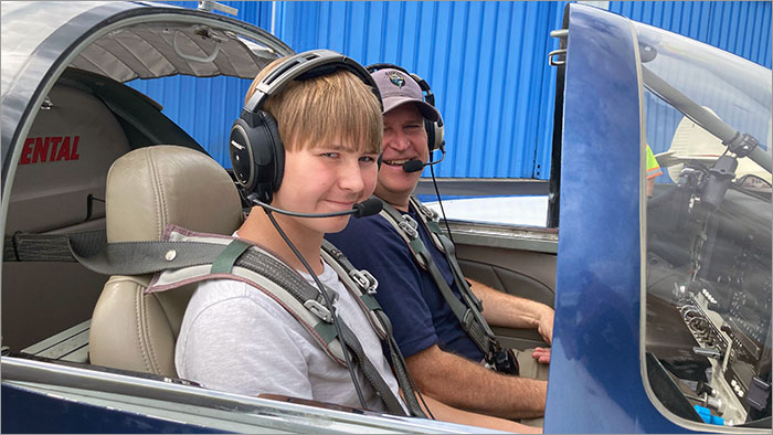 Boy and Pilot Inside Airplane Cockpit
